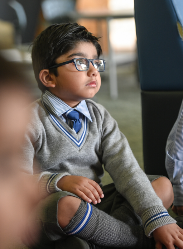 Student sitting in class listening to a teacher