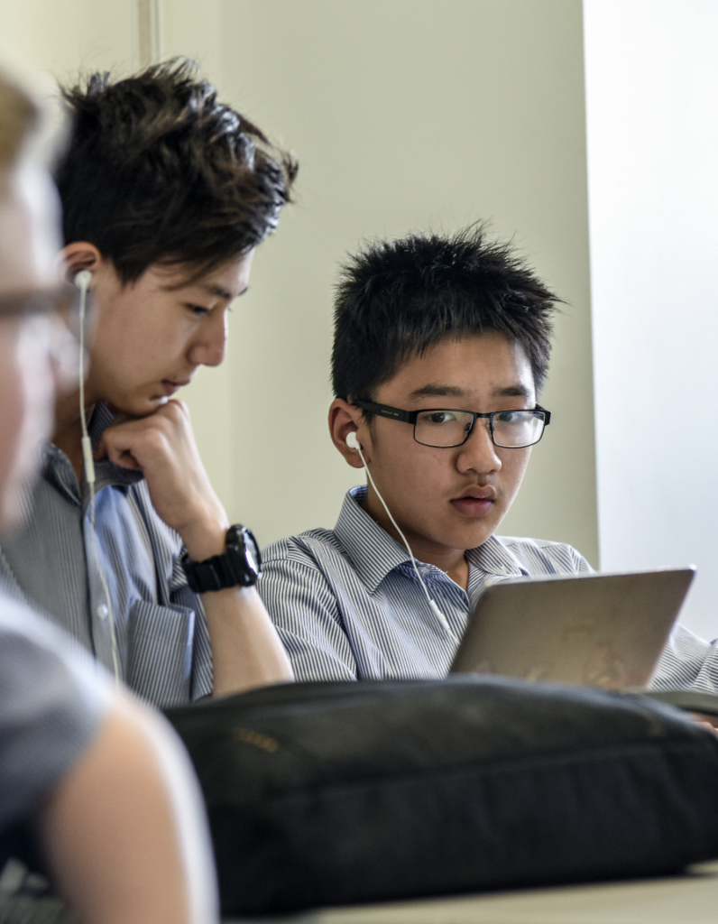 Students working in class on their laptops