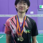 Young male athlete with medals at a badminton court, representing St Peters College in sports compet.